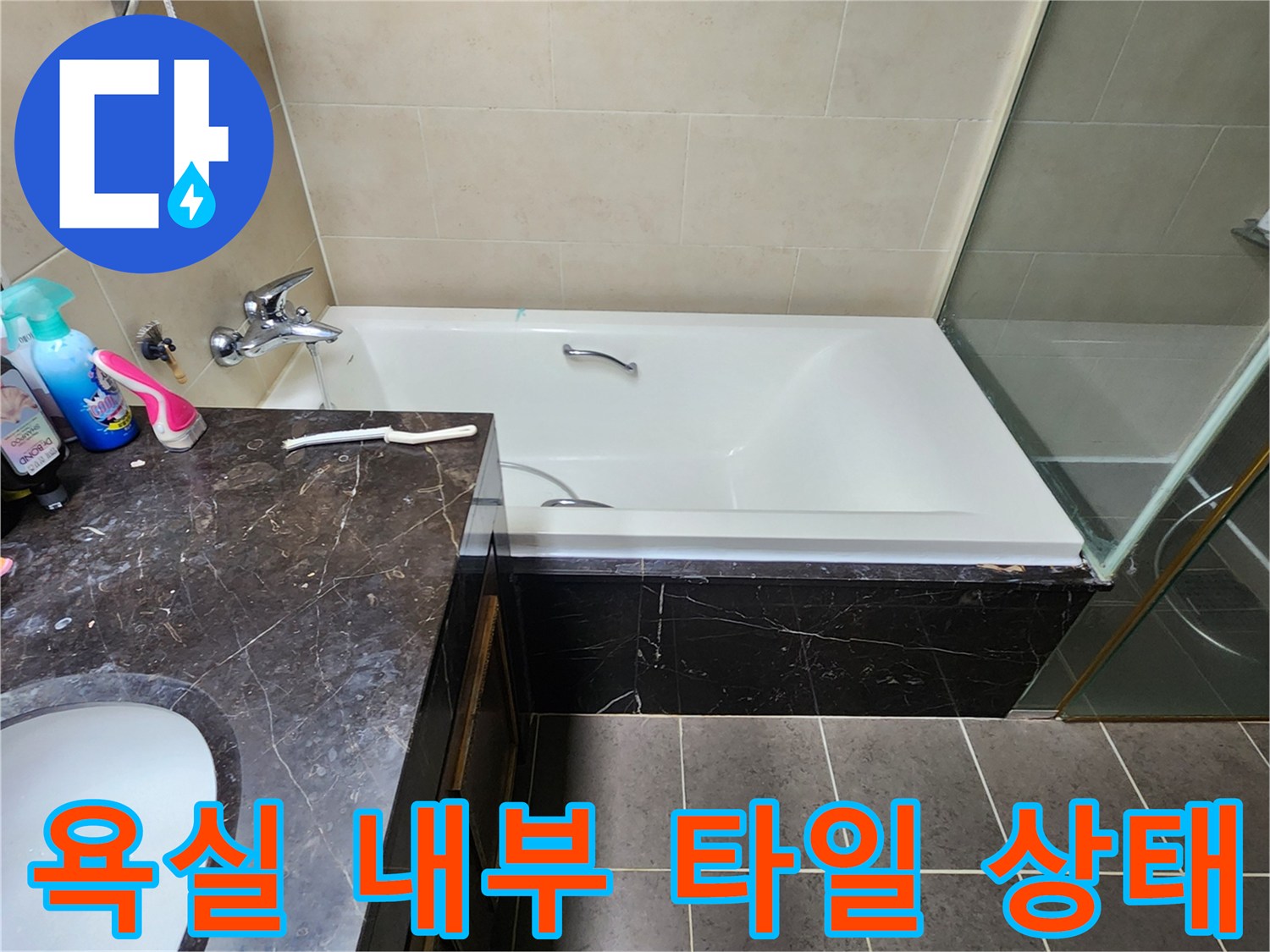 대리석 상판 세면대와 하얀색 욕조가 있는 욕실 모습