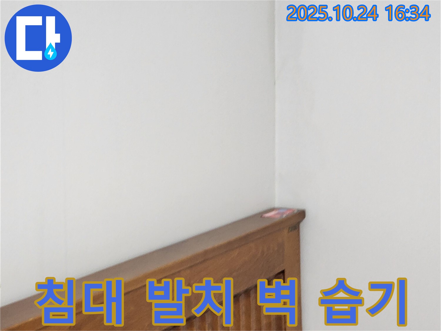 양주1동 봉우로 누수 현장 - 침대 발치 벽 누수로 인한 습기를 제거하는 누수 전문가의 습기 제거 작업