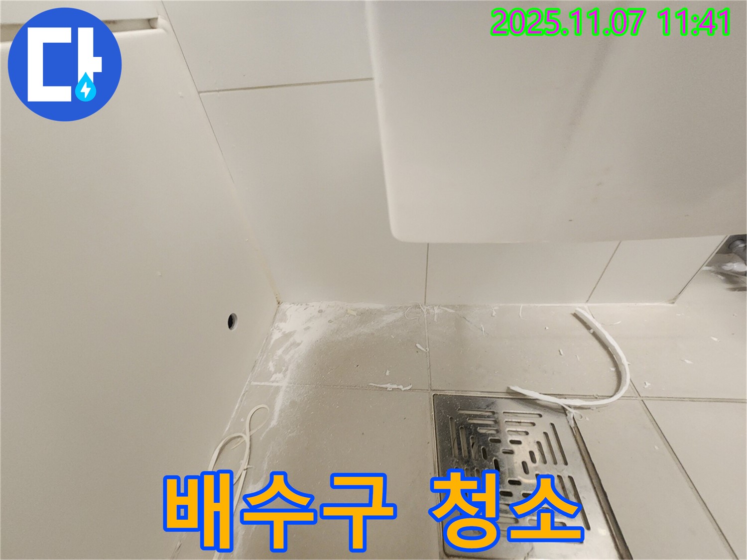 김포 사우동 누수 현장 - 배수구 주변을 깨끗하게 청소하는 작업 사진입니다.