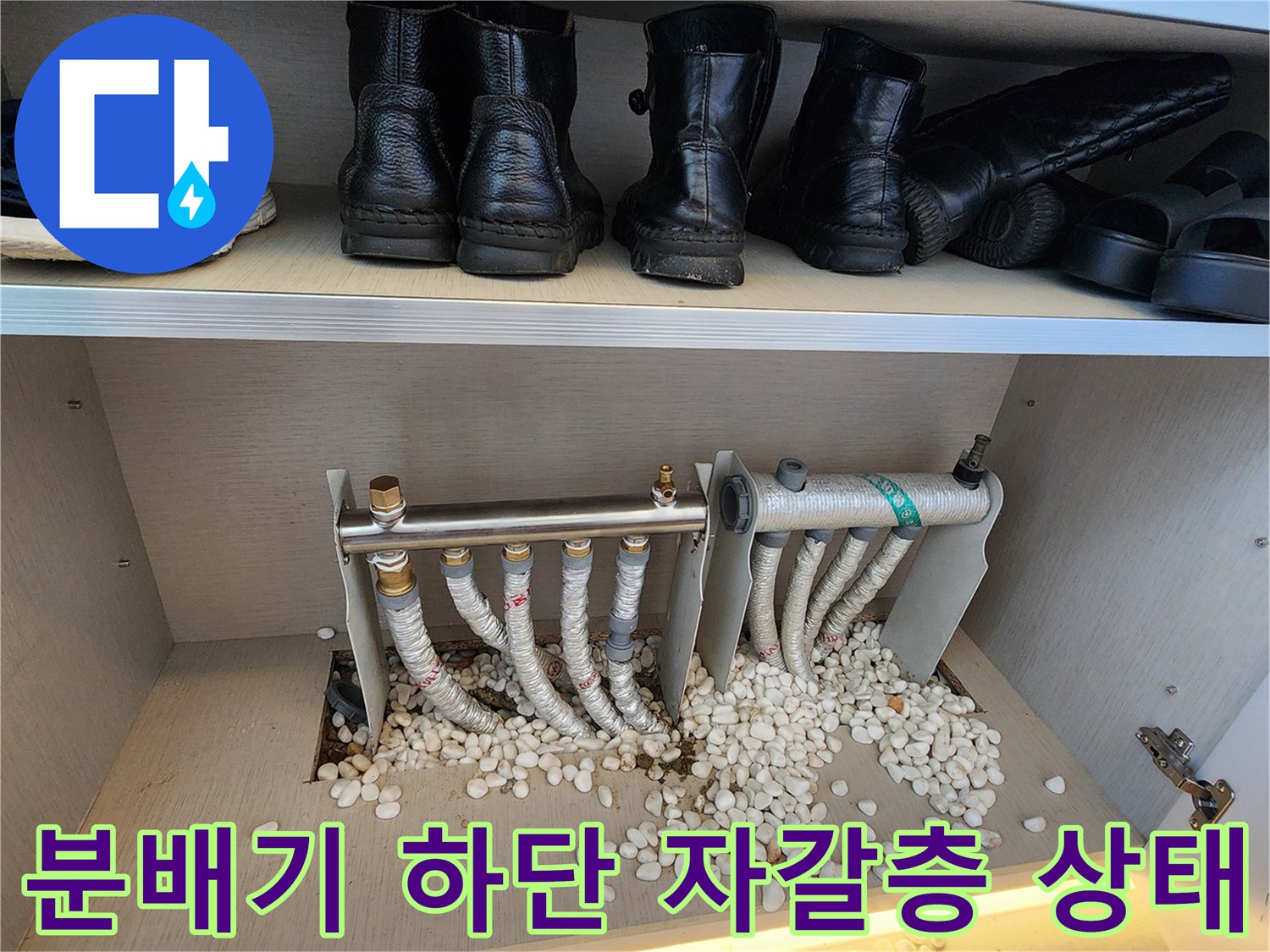 보온재로 감싸진 배관-주변에 흩어진 자갈과 습기 흔적