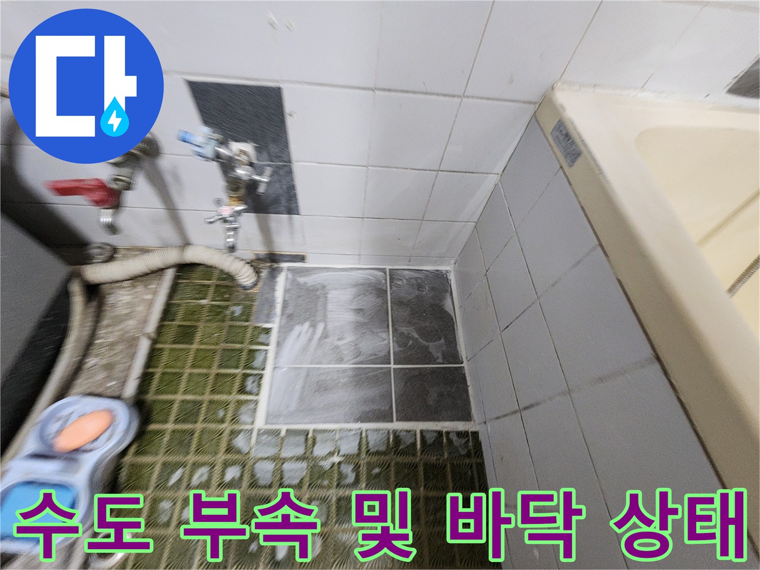 벽면 수전 연결부와 젖은 바닥 타일의 근접 촬영