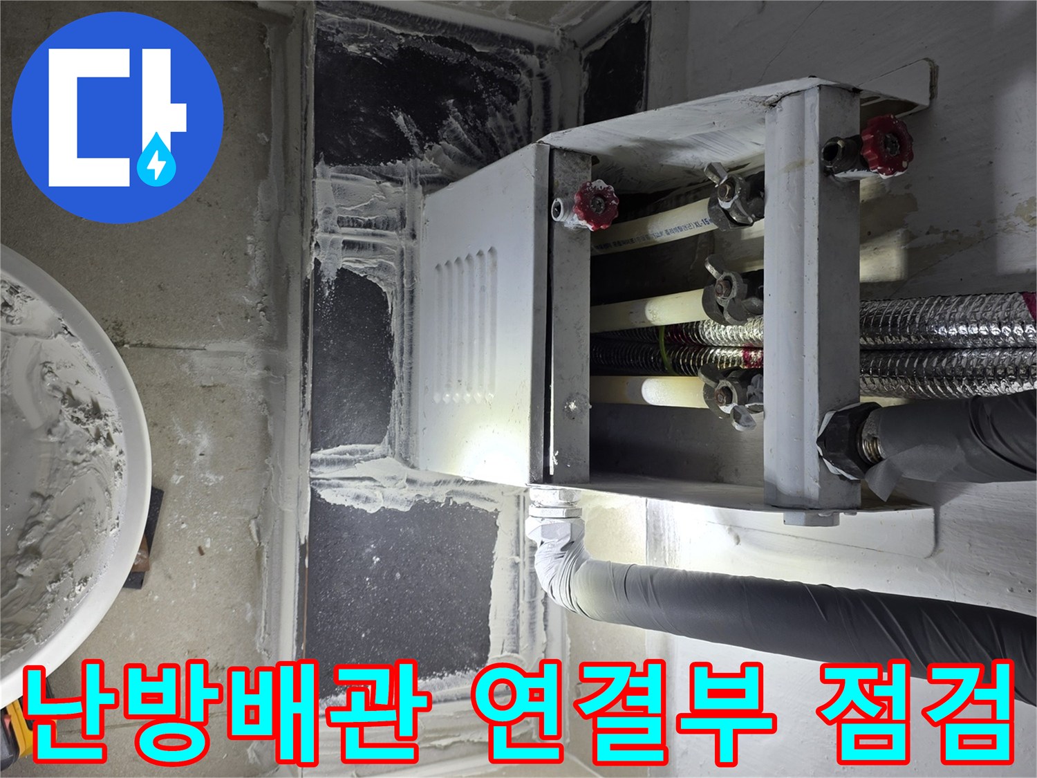 분배기-하단-배관-연결-상태를-정밀하게-조사하는-장면