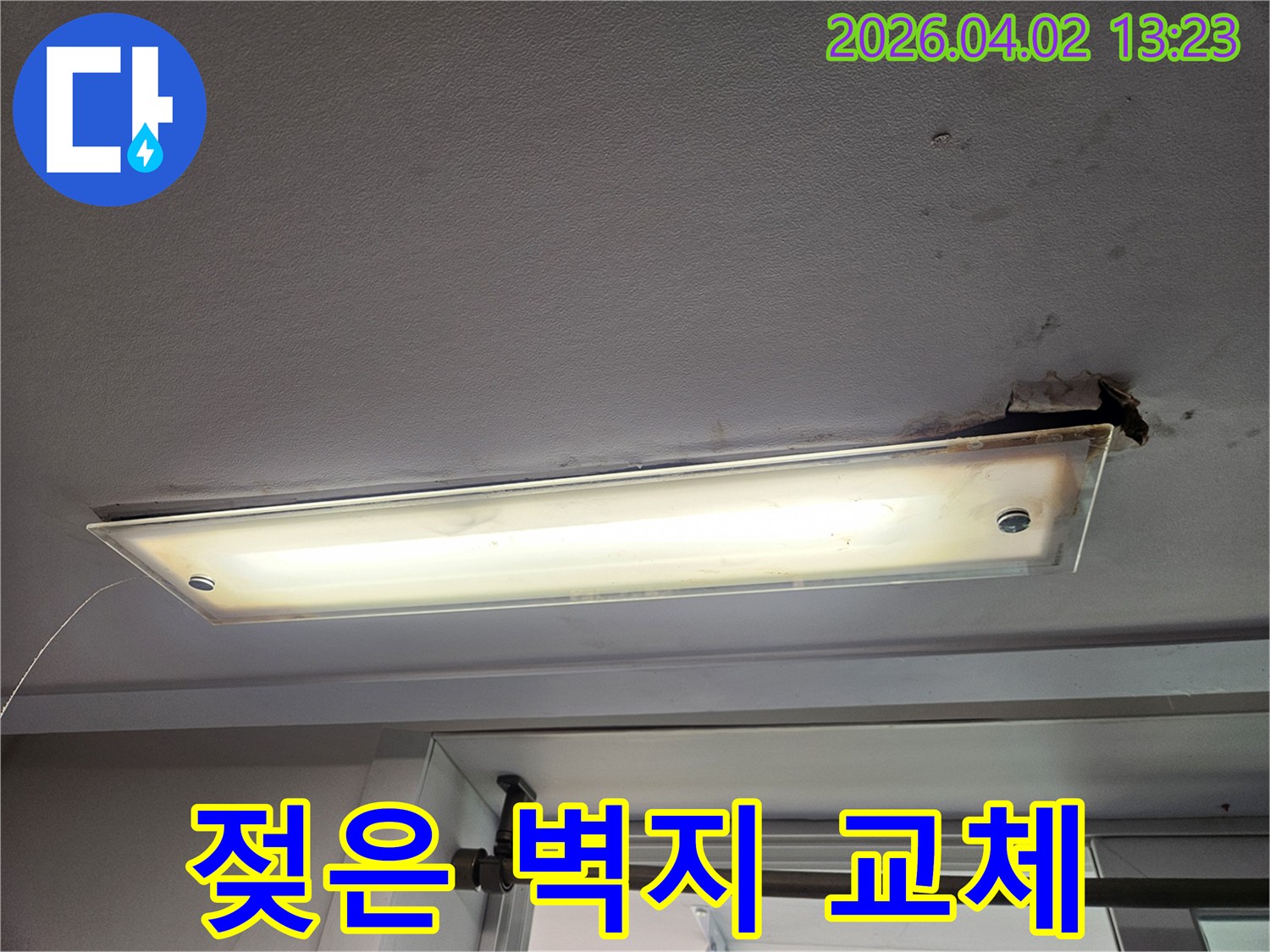 주택 천장 형광등 주변의 벽지가 물에 젖어 손상된 누수 현장과 교체 작업이 필요한 상황을 보여주는 이미지