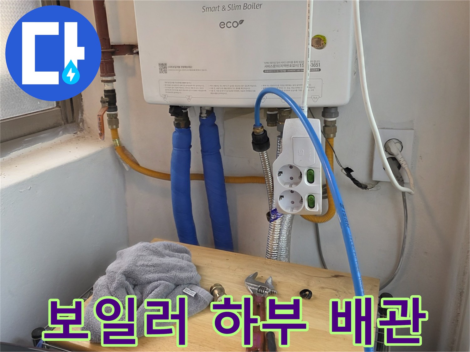 보일러-하부의-파란색-온수배관과-전기콘센트-모습