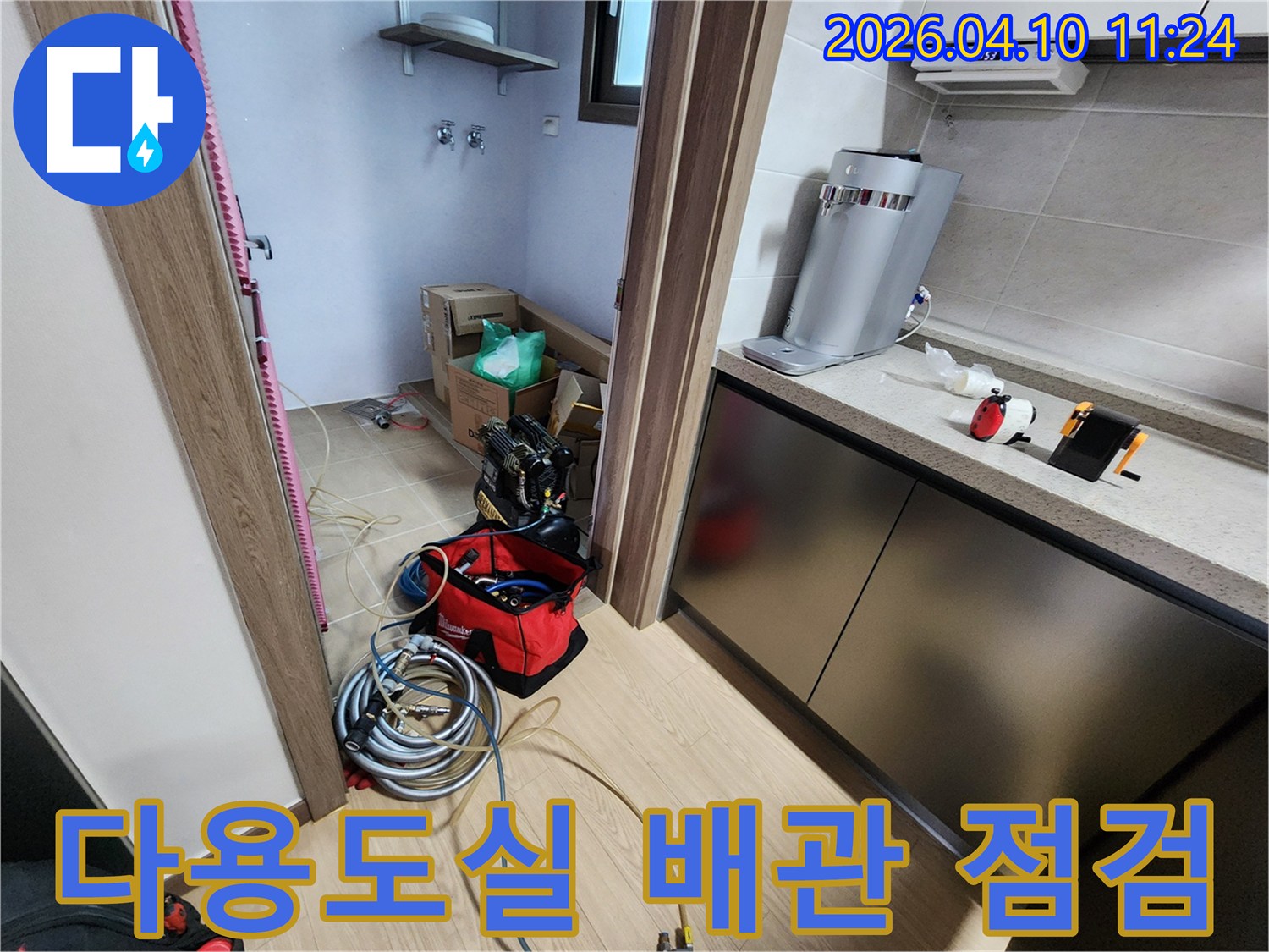 평택 아파트의 다용도실에서 발생한 누수를 해결하기 위해-배관 점검 장비들을 준비하는-전문가의 작업 현장입니다