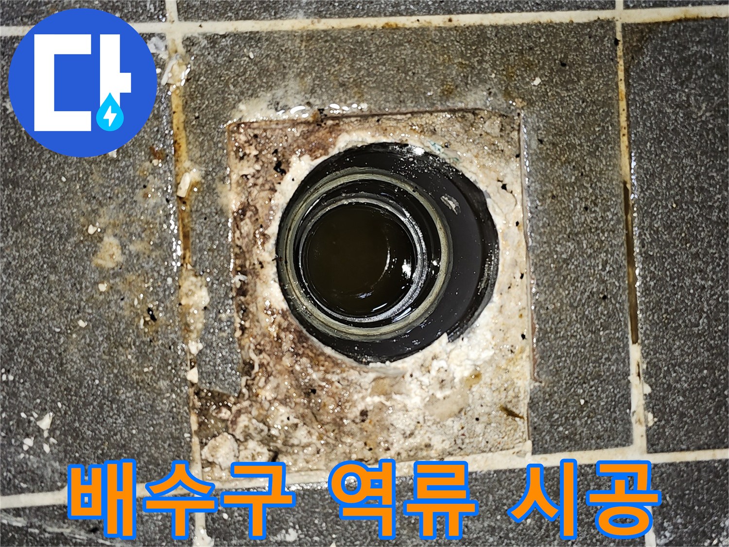 배수구에서 오수가 역류하여-바닥에 고여있는 모습을 보여주는-긴급한 누수 상황의 사진입니다.