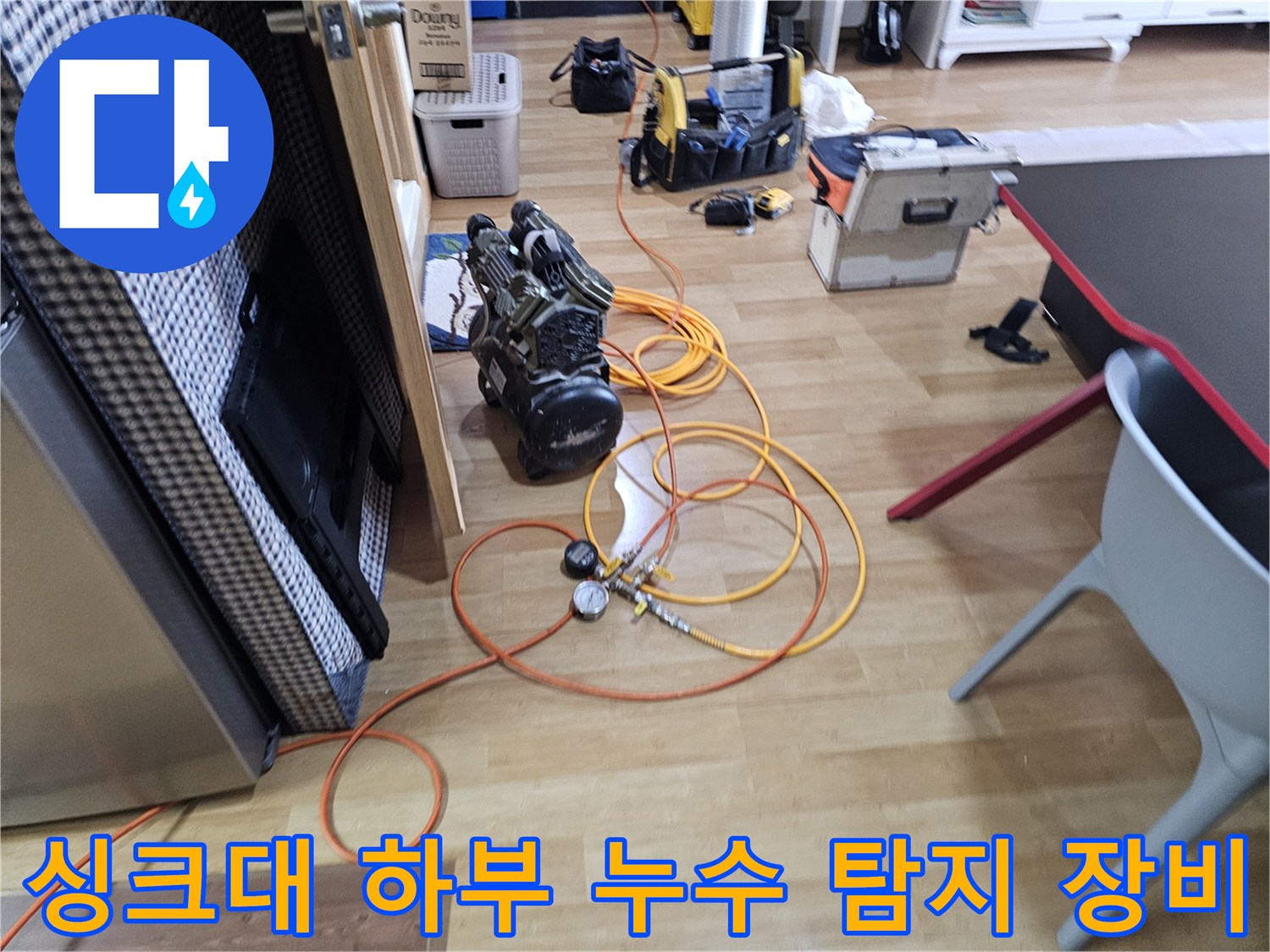 주방 싱크대 밑에서 작업 중인 가스 탐지기와 압력 측정 장비