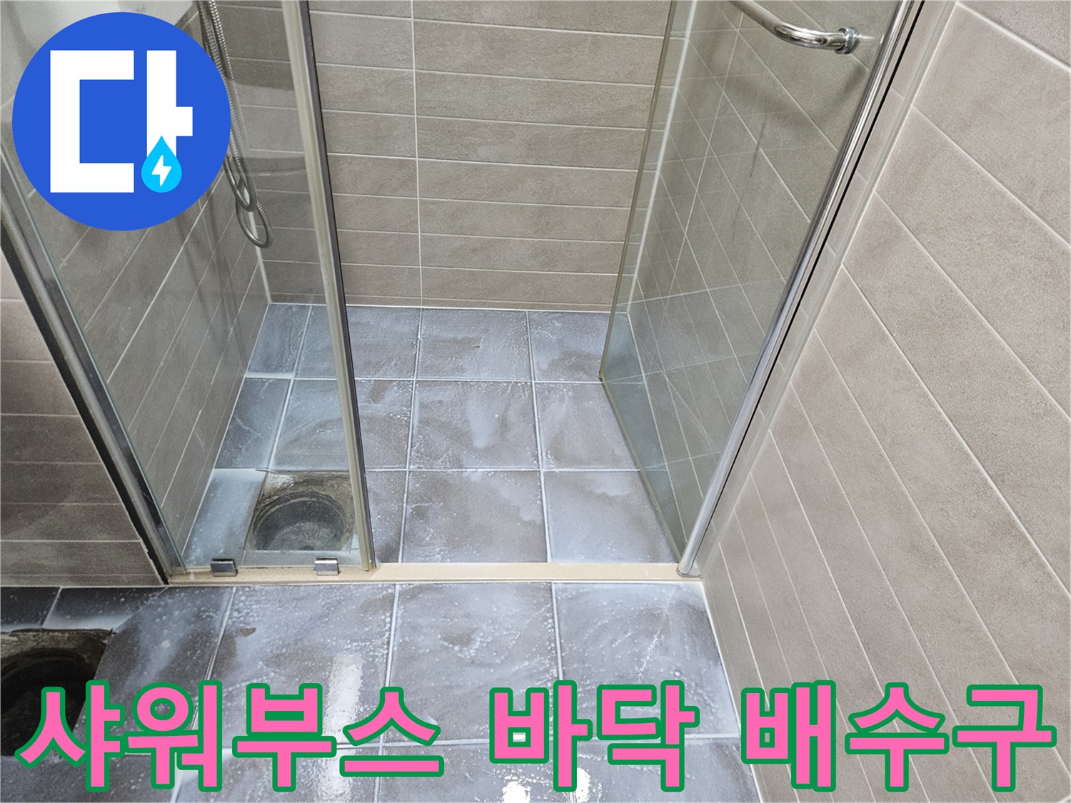 샤워 부스 내부 타일과 유가 배수구 근접 촬영