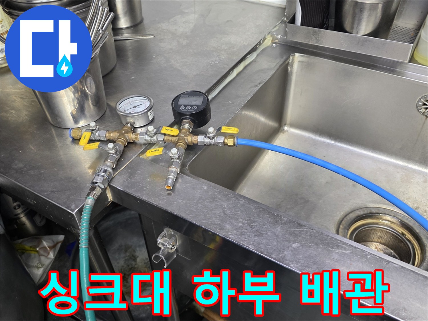 스테인리스 싱크대 아래 설치된 압력 측정용 배관 장치