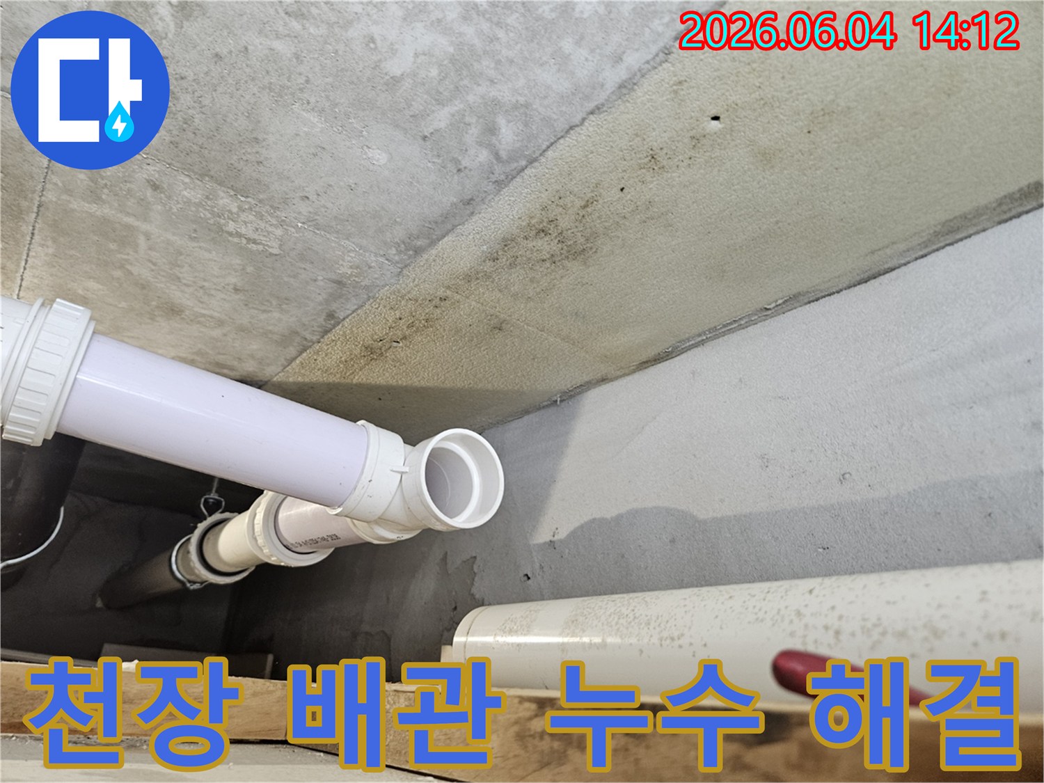 콘크리트 천장 아래에 설치된 PVC 배관 주변에-누수로 인한 광범위한 곰팡이와-오염이 발생한 현장 이미지