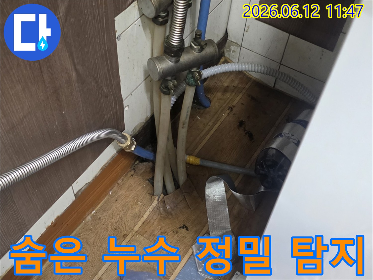 싱크대 하부의-복잡한 배관들 사이에서-정밀 장비를 사용하여-숨겨진 누수 지점을-찾아내는 엔지니어의 작업