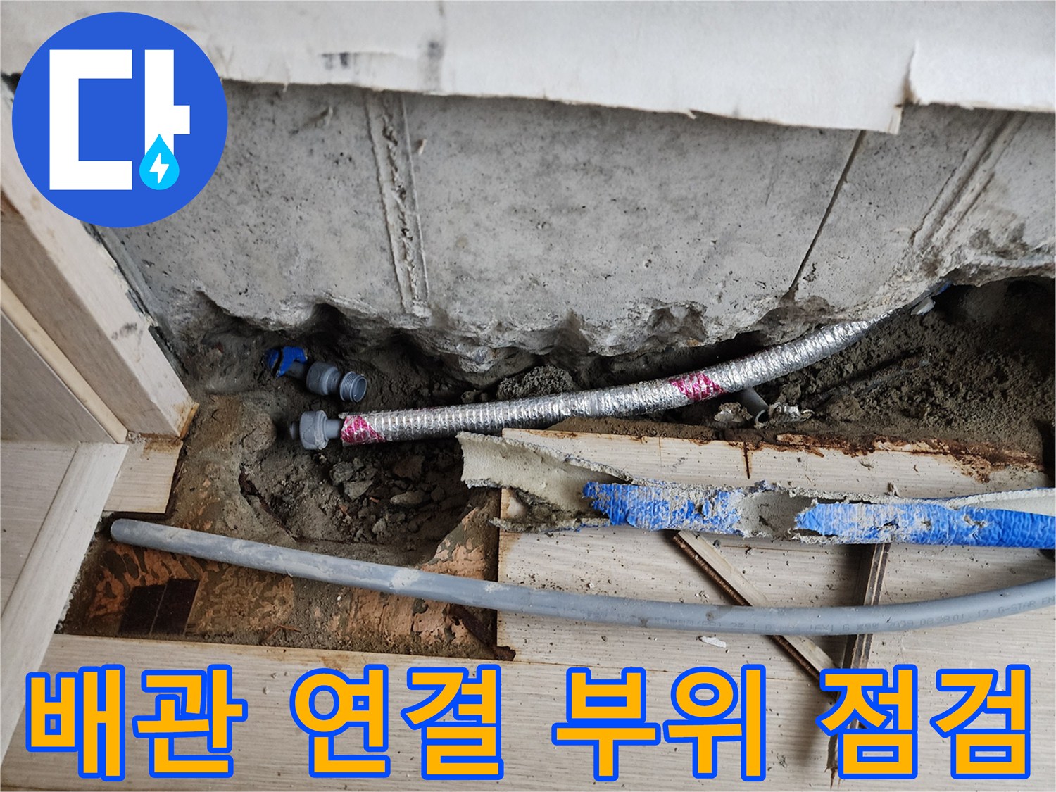 서초동 현장-시멘트 층 아래 노출된 은색 주름관과 파란 배관의 상태