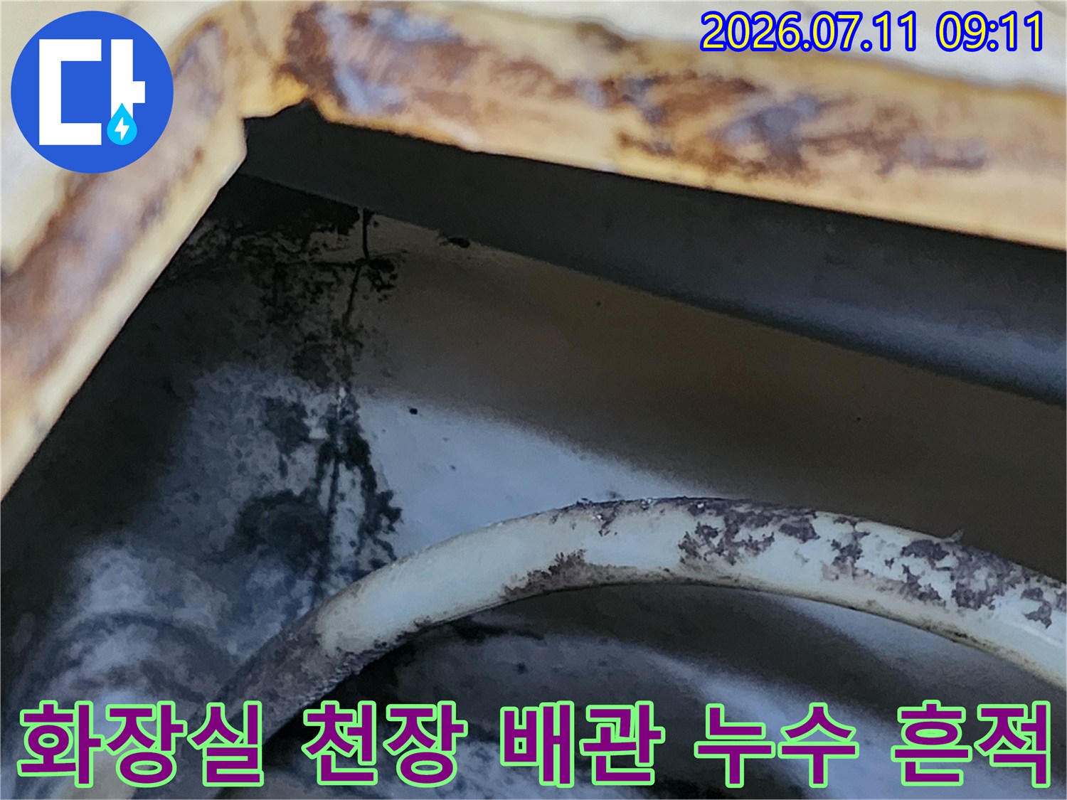 배관 주변에 고인 물과 곰팡이로 인한 오염이 발생한 화장실 천장 내부 모습