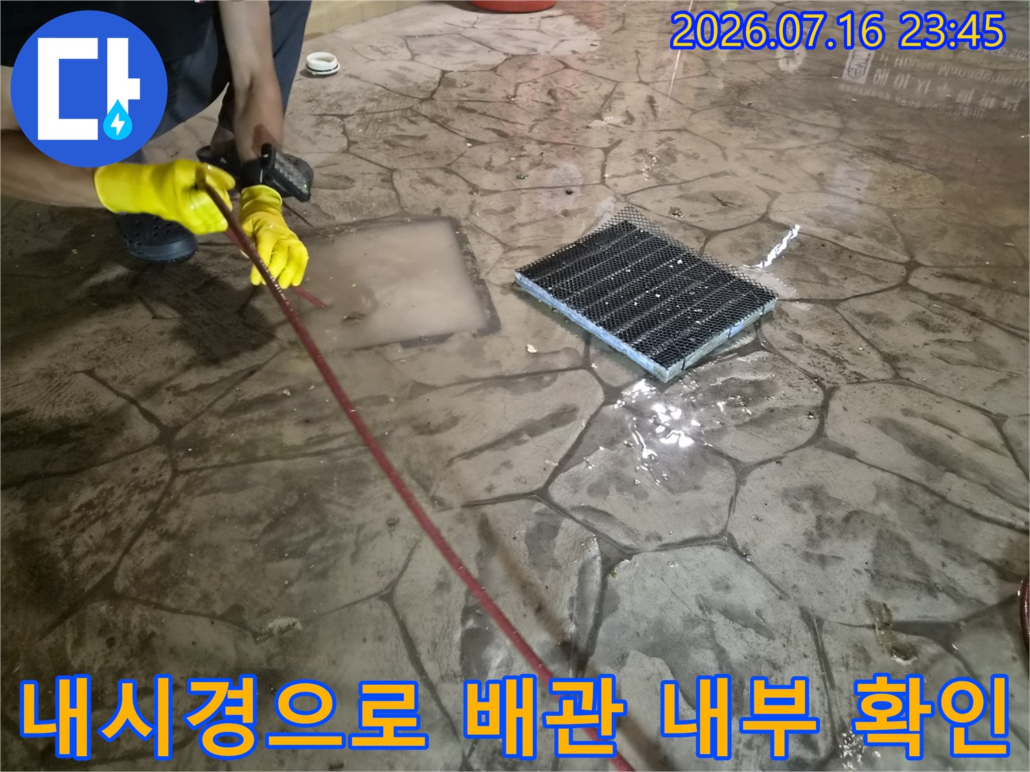 장비를 사용하여 배수구 내부에 쌓인 이물질을 시각적으로 파악하는 과정