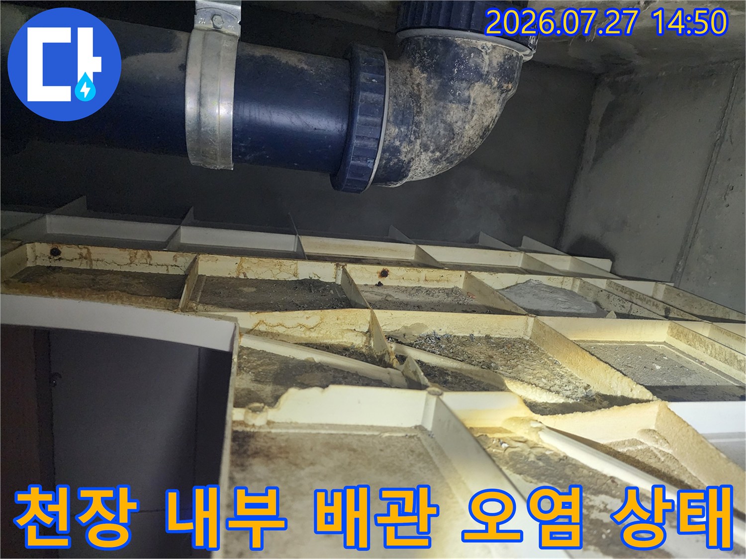 천장 마감재를 열어 확인한 파란색 pvc 배관과 그 주변의 누적된 오염물질-상태