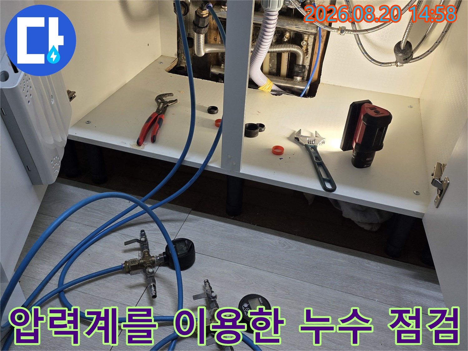 분배기 배관에 연결된 압력계와 측정용 호스 장비입니다.