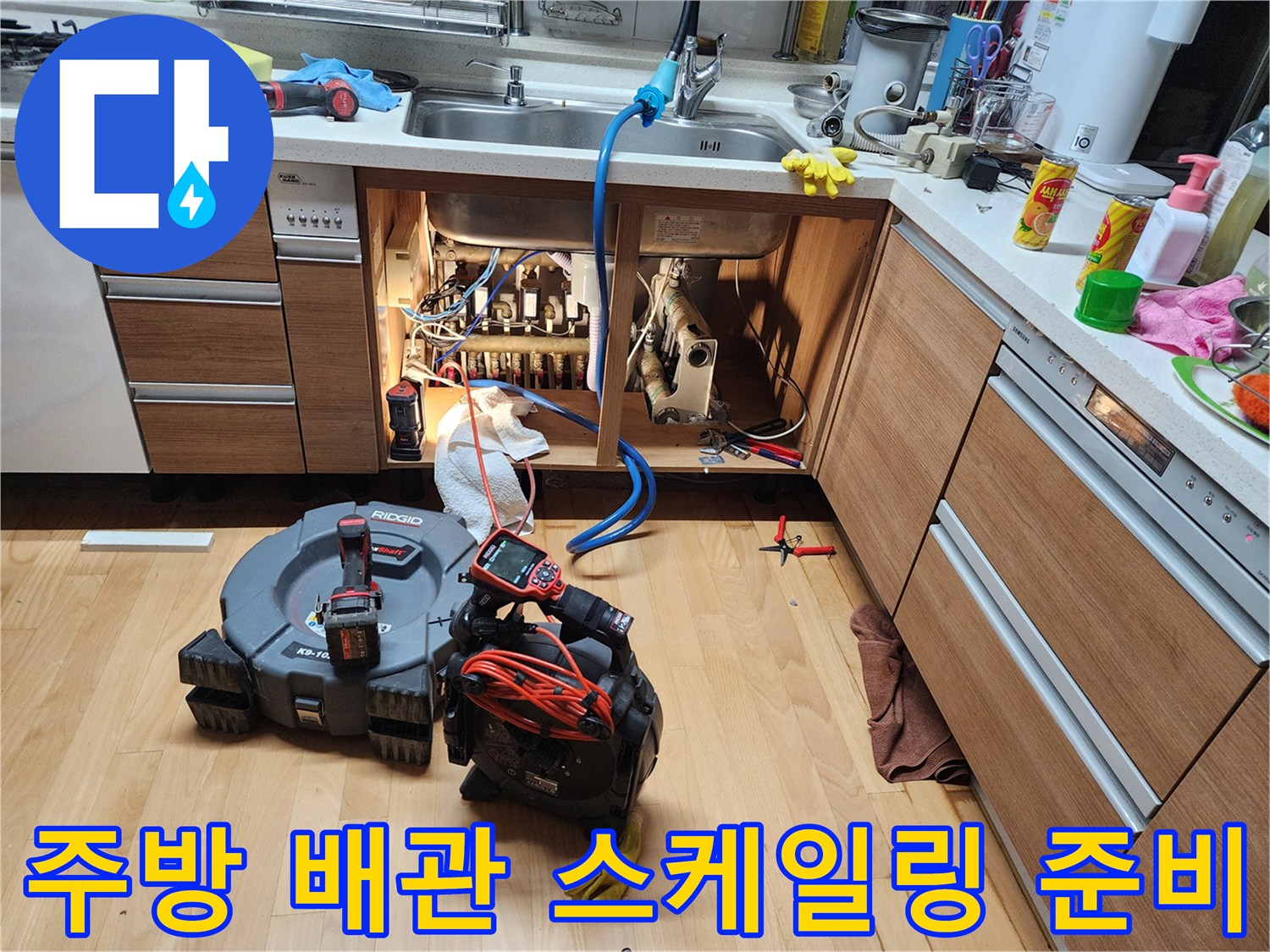 싱크대 하부 배관 주변에 배치된 배관 청소용 전문 장비들