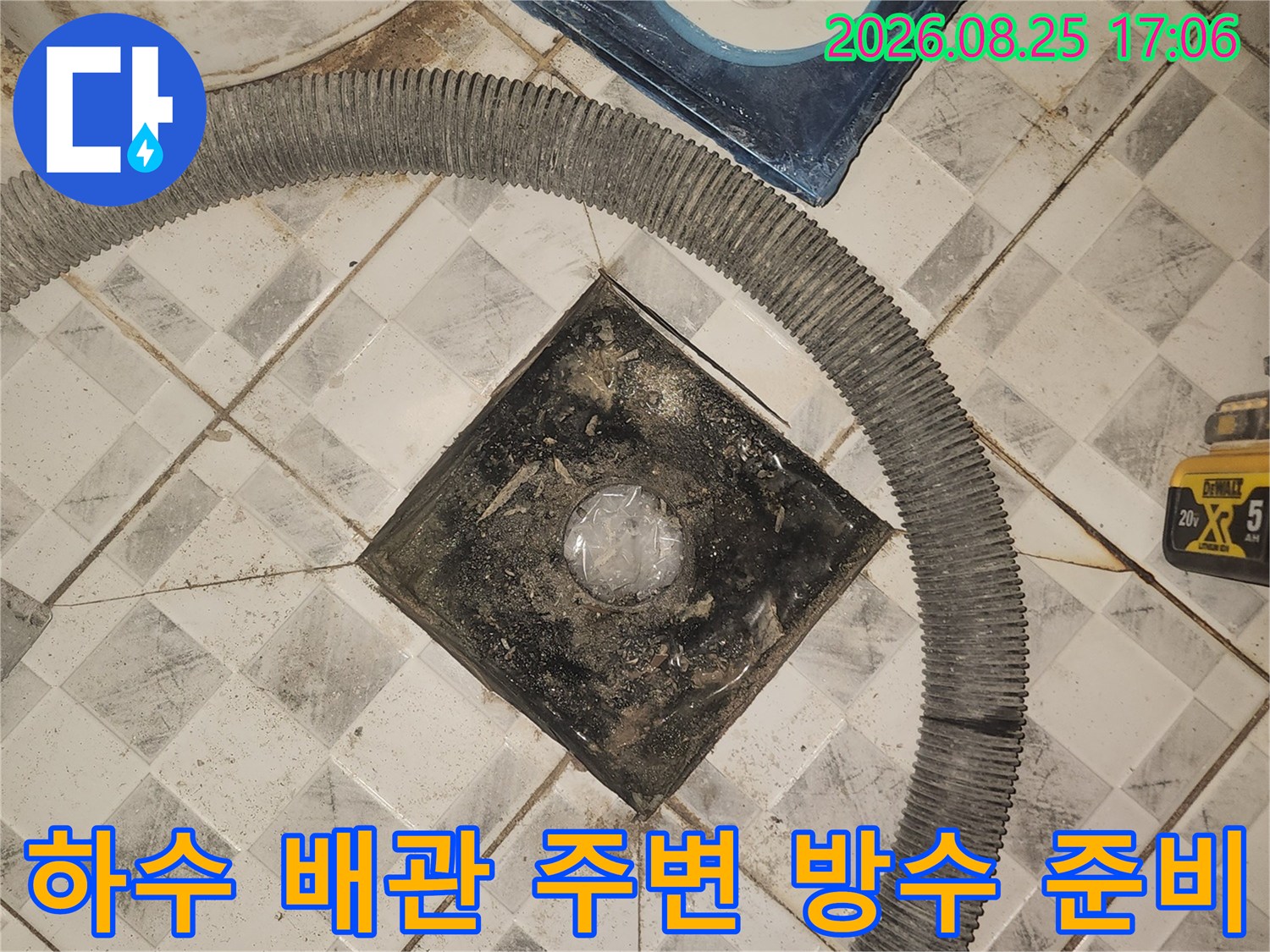배수구 주변의 노출된 배관과 탈거된 유가 부속품입니다.