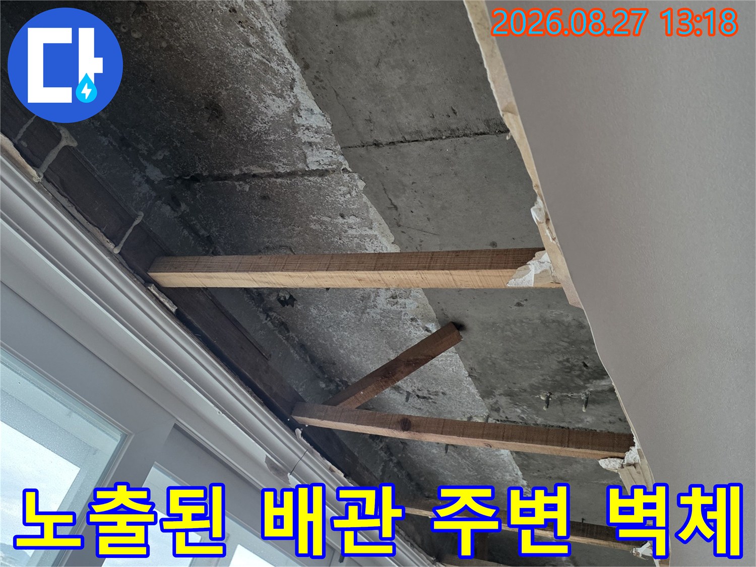 창틀 아래쪽-콘크리트와 목재 구조물이 드러난 누수 점검 부위