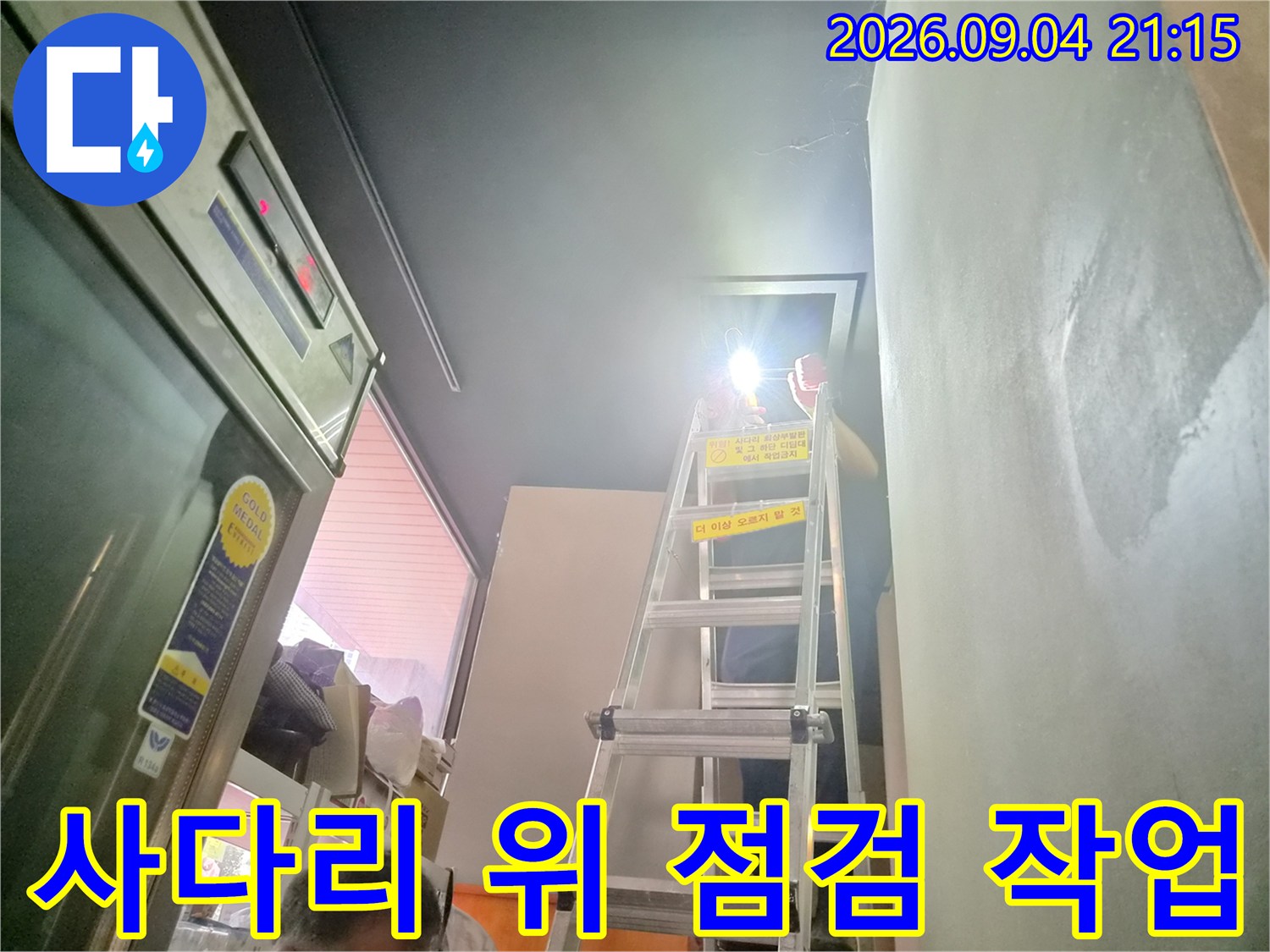 사다리에 올라가서-천장 배관의 누수 여부를-면밀히 관찰하는 엔지니어