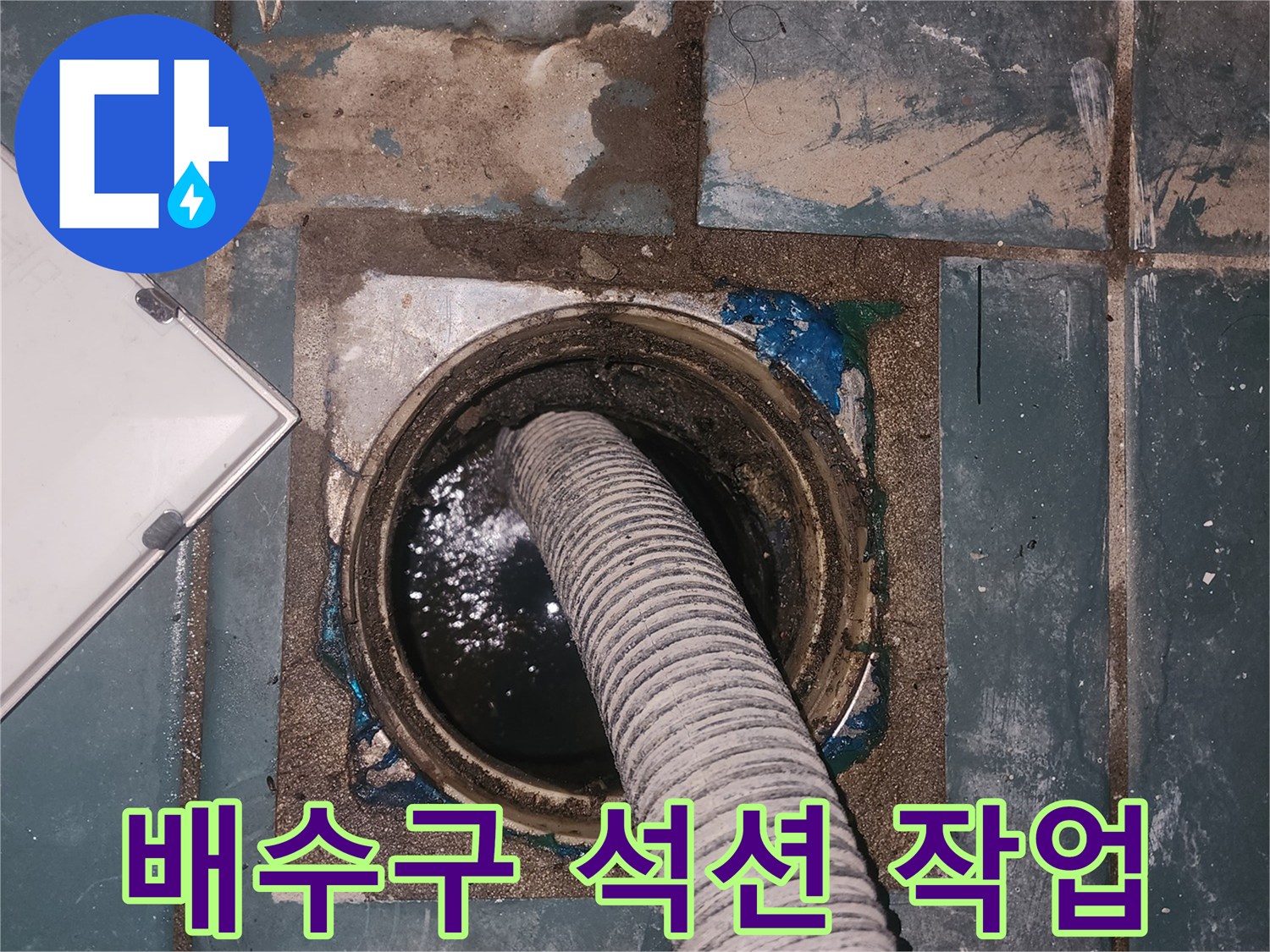 세탁실 배수구 내부 오염물 제거를 위한 석션 장비 사용 중