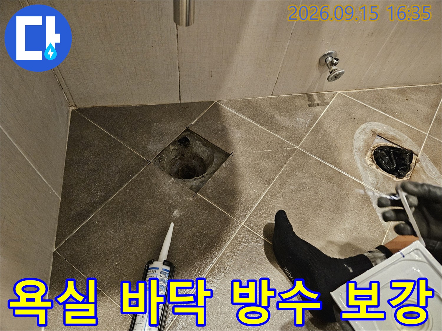 파손된 타일 틈새를 실란트로 메워 누수를 방지하는 전문 공사 현장